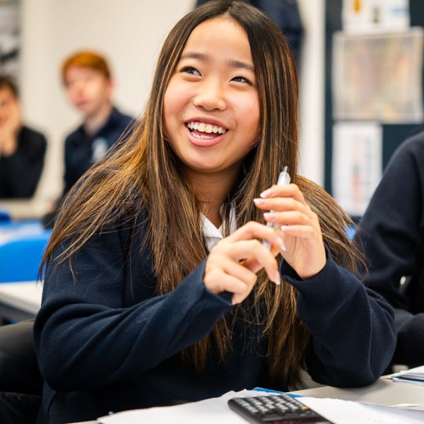 King's Ely International student laughing in classroom. King's Ely is a private boarding school in Cambridgeshire. 