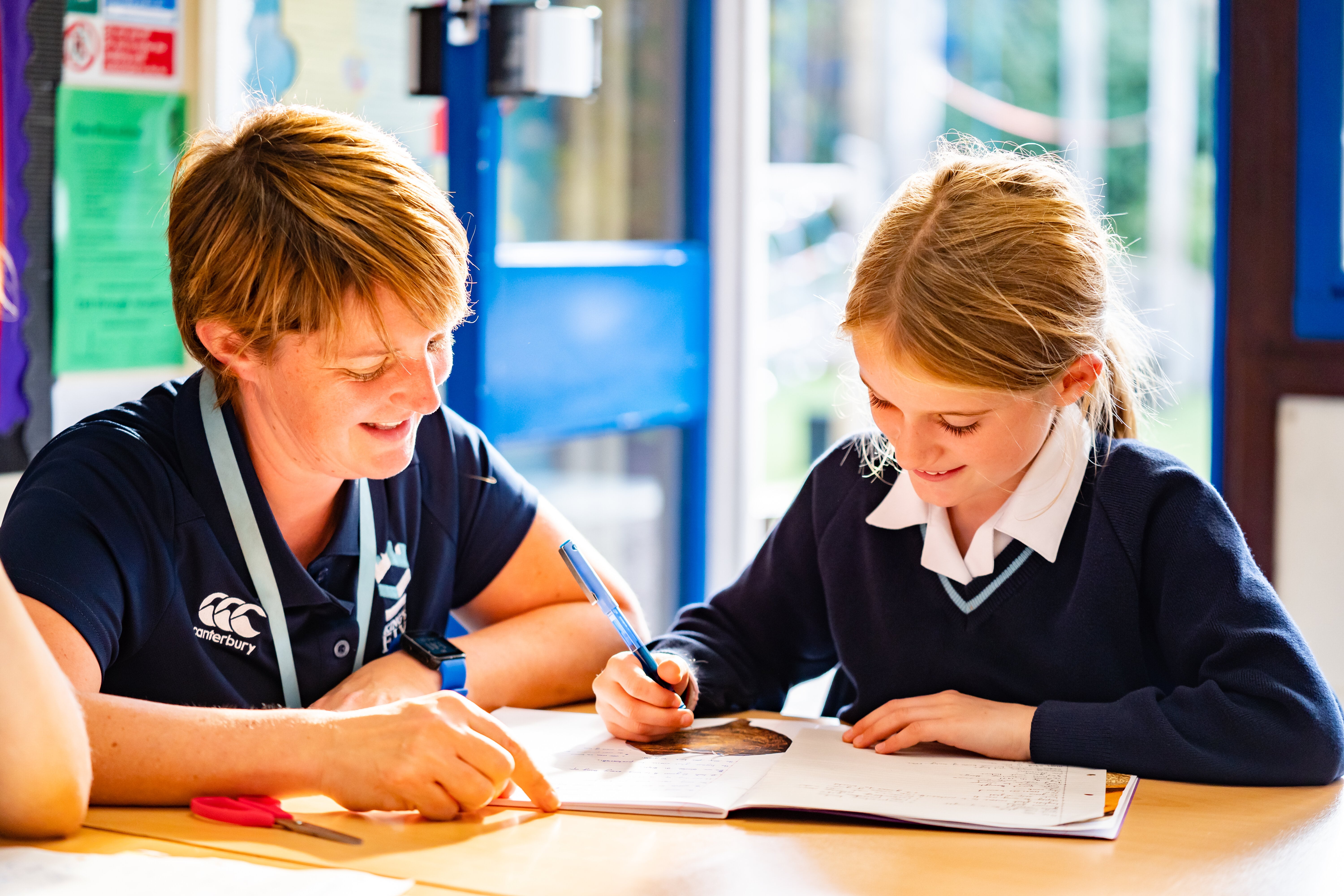 King's Ely Prep teacher helping Prep  student in classroom  