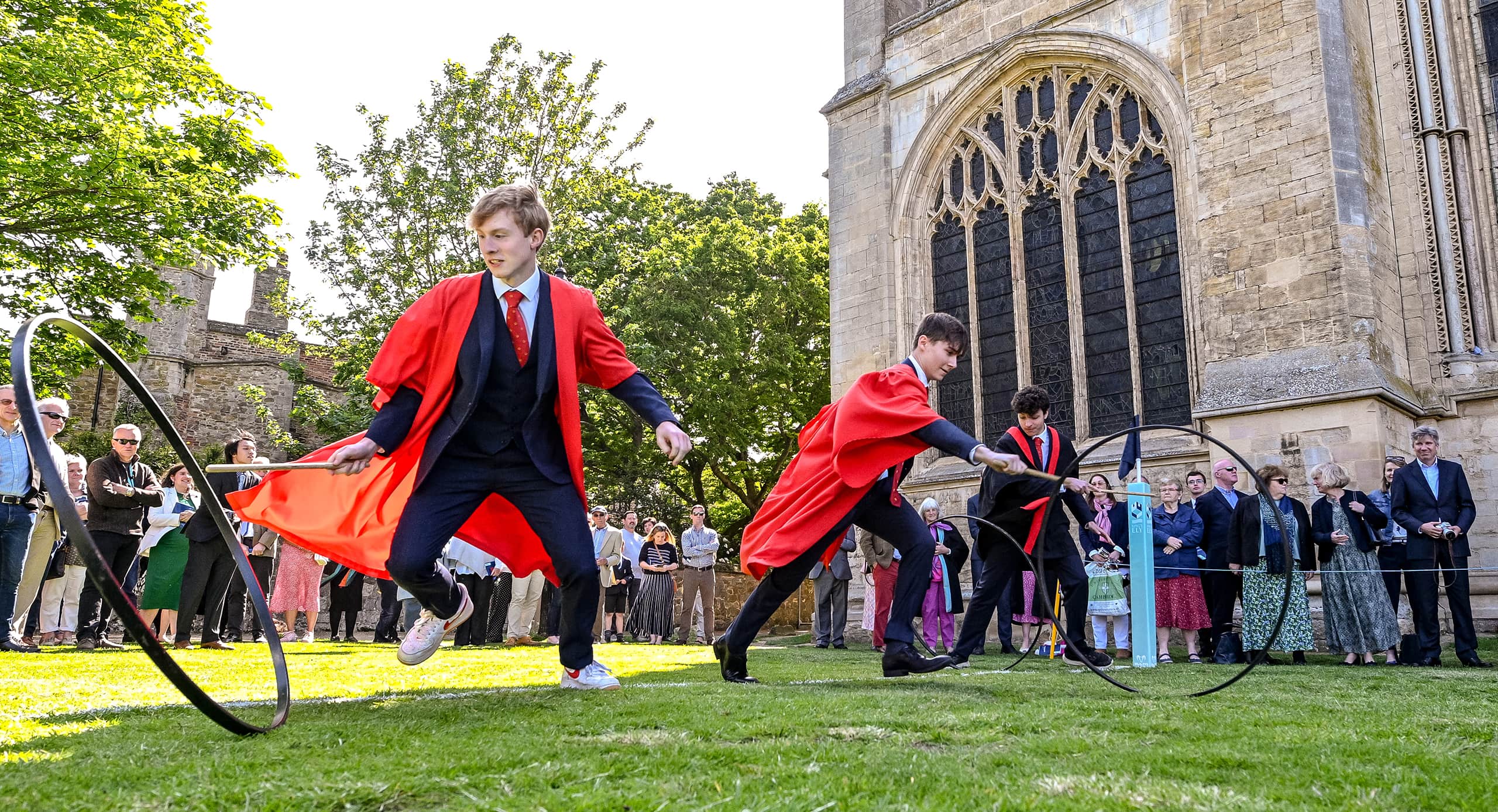 King's Ely Sixth Form students doing the Hoop Trundle outside Ely Cathedral 